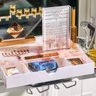 Clear Lucite menorah with gold cups on the painted menorah tray for Chanukah, drawer open showing candles and lighting essentials