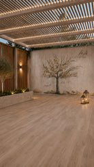 Painted by Judy Family Tree vinyl sukkah mural on a sukkah wall in a modern pergola with wood floors and a candle lantern