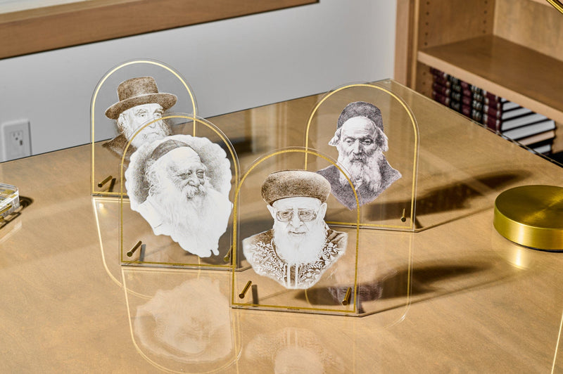 Set of modern acrylic plaques featuring portraits of revered rabbis, designed with gold-tone accents and displayed on a polished desk for elegant Jewish home decor. | Waterdale Collection