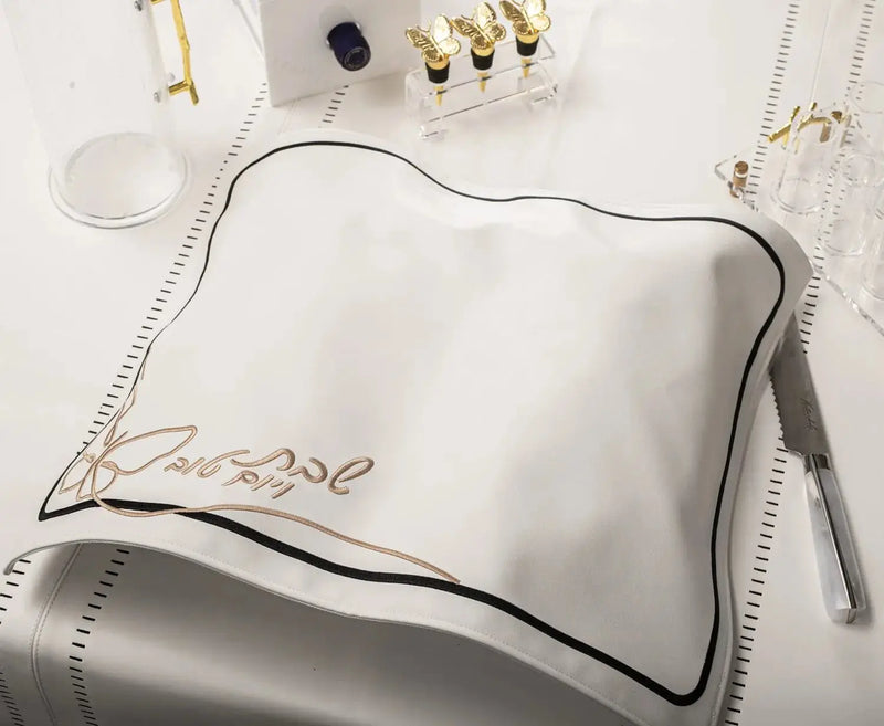 Butterfly Challah Cover in silver leather with gold embroidered butterfly details, displayed flat on white background with matching accessories.
