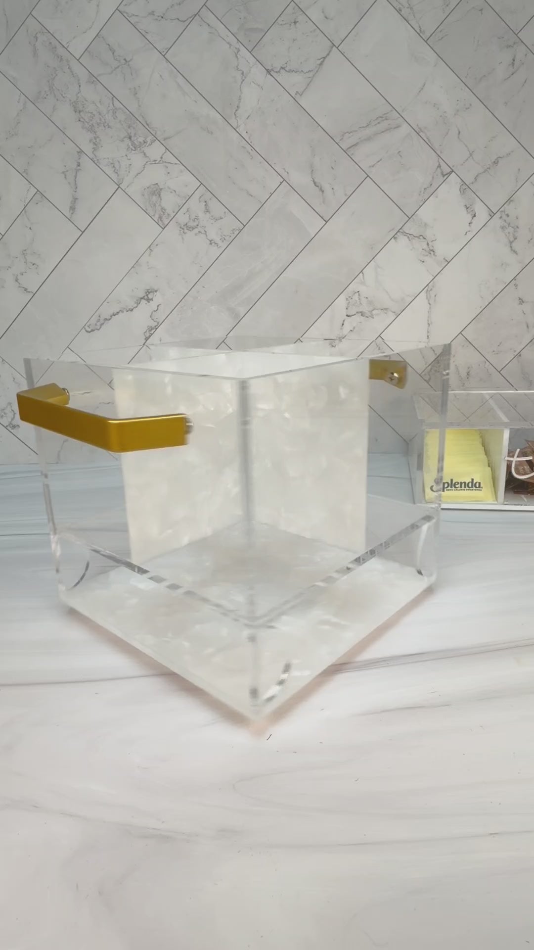 Swivel acrylic flatware caddy with pearl center divider and gold handles on a counter setting with items in it and spinning around. by Waterdale Collection