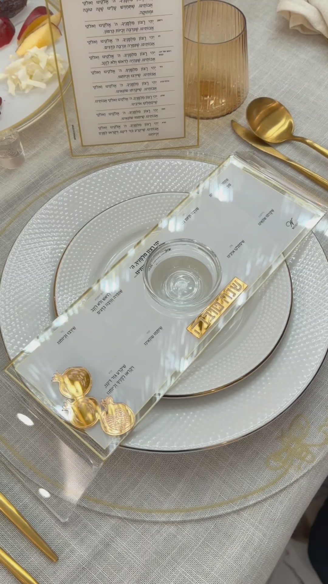A hand placing all the food items on the personal raised simanim tray.