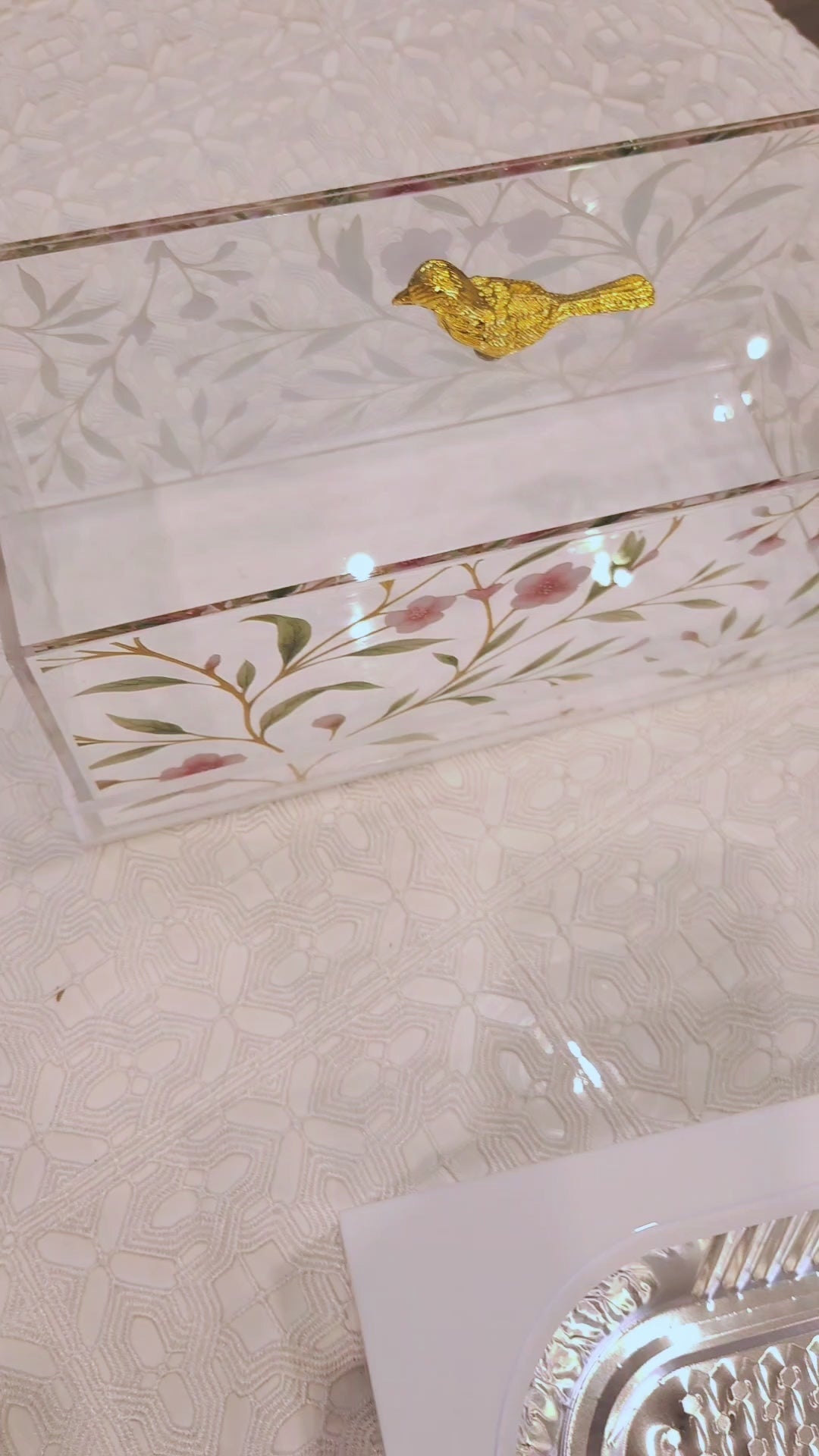 Floral Bird design 9X13 pan holder being open and closed. White acrylic with floral design and gold bird knob on top. Clear acrylic block handles.
