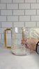 Floral Bird Washing cup with gold handles and pink or gold flower accents. Water in the washing cup
