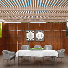 Modern wooden sukkah with 2 Piece Onyx Sukkah Decoration Set, a dining table with white tablecloth, and gray chairs.