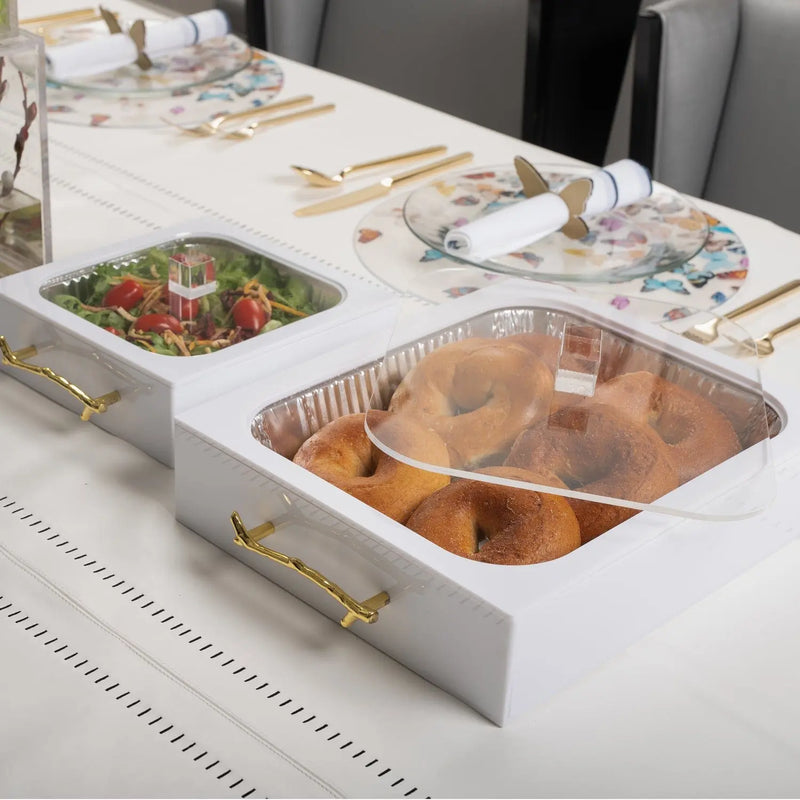 Twig 9x13 pan holder with white base holding gold aluminum pans on a styled table setting with place cards and serveware.