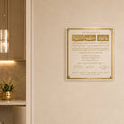 A gold-framed AL HAMICHYA plaque mounted on a beige wall in a modern interior setting.