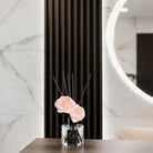 Minimalist pink floral diffuser with natural reeds, contemporary blush rose scent by Waterdale Collection for sophisticated Shabbat and holiday home styling.