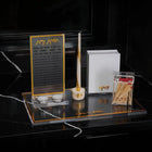 Waterdale Collection Hadlokas Neiros candle lighter set displayed on black marble with gold accents and white box packaging.
