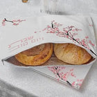 Cherry Blossom Challah Pouch Cover in white with pink floral design, holding two round loaves, leather construction by Waterdale Collection