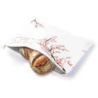 White Cherry Blossom Challah Pouch Cover with delicate floral design, containing a fresh challah loaf, perfect for Shabbat table settings.