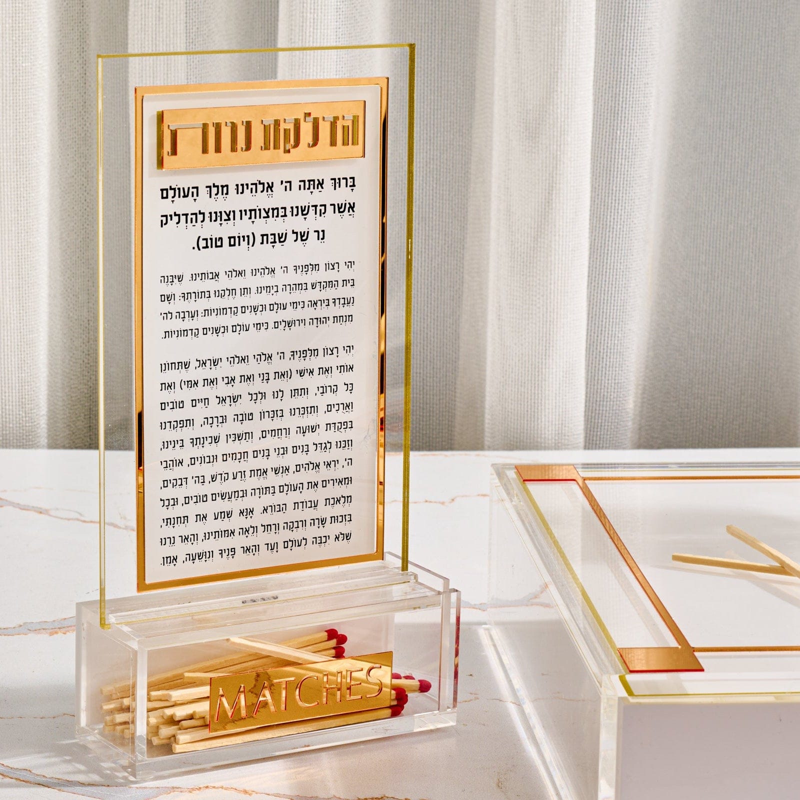 Classic 2.0 Hadlokas Neiros Match Cloche Card featuring gold-accented Hebrew candle lighting prayer in clear acrylic frame with built-in match holder base, elegant modern Shabbat tabletop display.