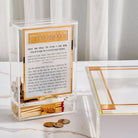 Classic 2.0 Hadlokas Neiros Match Tzedakah Box in clear and gold acrylic, Shabbat candle lighting prayer box with built-in match holder and tzedakah compartment, modern Judaica gift for Shabbos and Yom Tov.