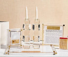 Classic 2.0 Hadlokas Neiros Set by Waterdale Collection featuring gold candlesticks, prayer book, and matches on white surface.