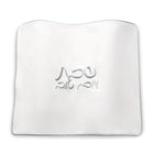 White fabric challah cover with embroidered Hebrew text from Waterdale Collection's classic bread board set