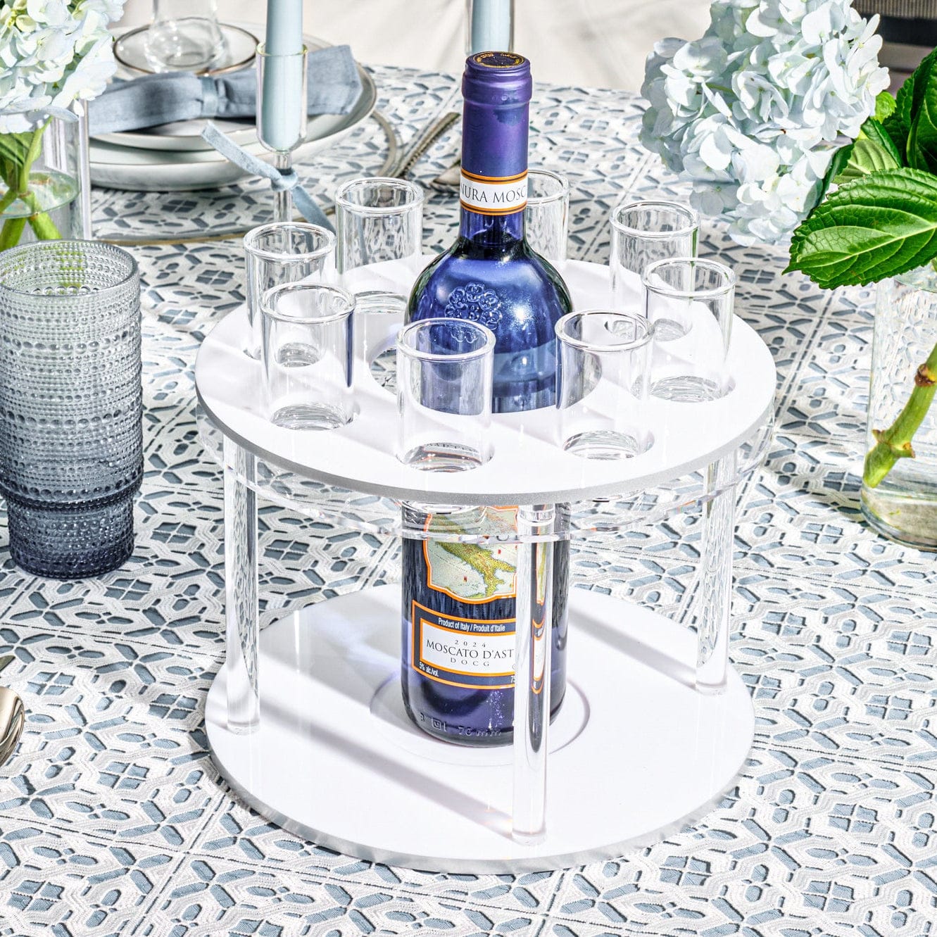 Classic Round Liquor Set featuring sleek two-tier acrylic stand with central bottle holder and matching shot glasses, modern serving station for Shabbos, Yom Tov, and elegant home entertaining, stylish bar display and upscale Judaica gift.
