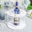 Classic Round Liquor Set featuring sleek two-tier acrylic stand with central bottle holder and matching shot glasses, modern serving station for Shabbos, Yom Tov, and elegant home entertaining, stylish bar display and upscale Judaica gift.