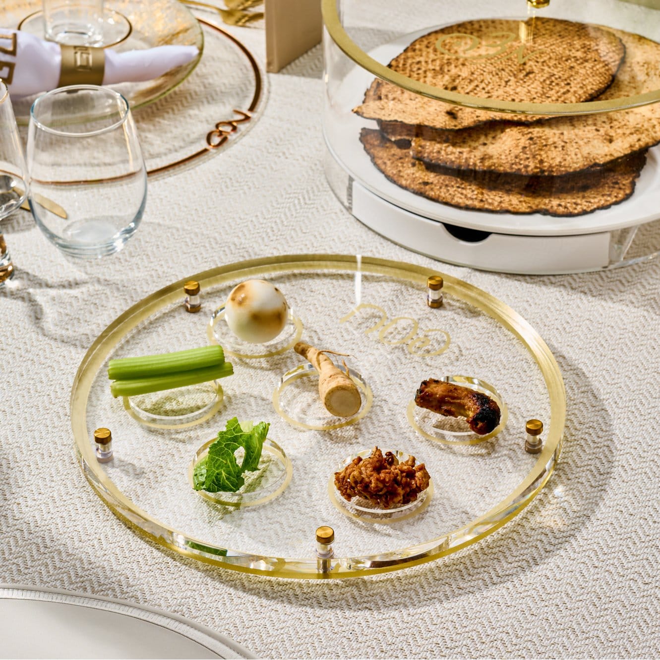 Elegant gold and lucite Classic Script Seder plate, luxury Passover tableware with gold-rimmed ritual bowls.