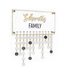 Custom calendar with family birthdays and anniversaries hanging. Crafted from clear lucite in clear with clear and black circles hanging from the main board. Your family name printed in the middle. 