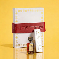 Elegant Mishloach Manot gift basket for Purim featuring premium wine, Hebrew-themed Judaica, and deluxe gift boxes