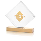 Luxury Passover Matzah holder, diamond-shaped lucite display with gold lettering and pedestal base for elegant Seder table decor.