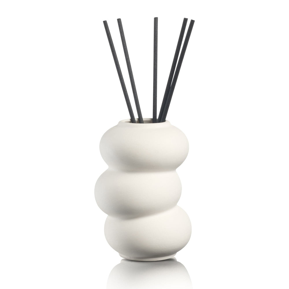 Minimalist circular hollow diffuser with natural reeds, stylish geometric aromatherapy vessel for sophisticated Shabbat and holiday tablescapes.