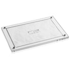 Acrylic Challah board featuring a white embossed leaf pattern center and silver Hebrew lettering "Shabbat V'Yom Tov," secured with four decorative corner bolts.