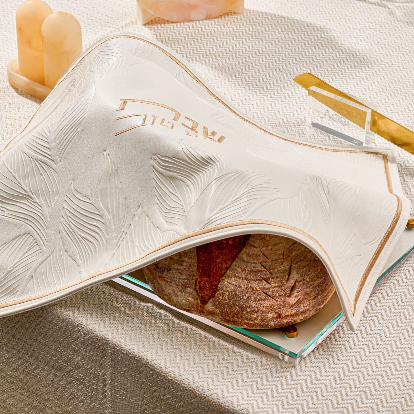 Leather and Lucite challah board and cover on a set shabbos table from waterdale collection