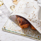 Embroidered leaf challah board with matching cover set displayed on white table with wine glasses and fresh bread