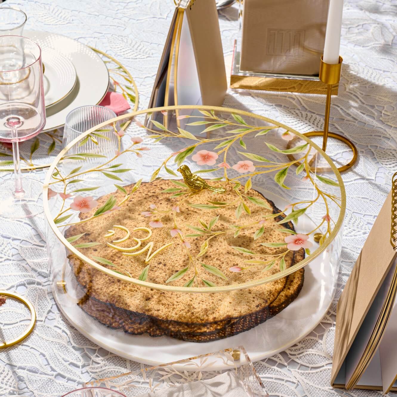 Floral Bird Matzah Box with gold rim and cherry blossom design, featuring a decorative gold bird handle and Hebrew 'Matzah' lettering.