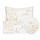 Floral bird Pesach set in white and gold featuring delicate botanical artwork, Passover pillow, matzah plate, afikoman bag, and towel with Hebrew lettering | Waterdale Collection