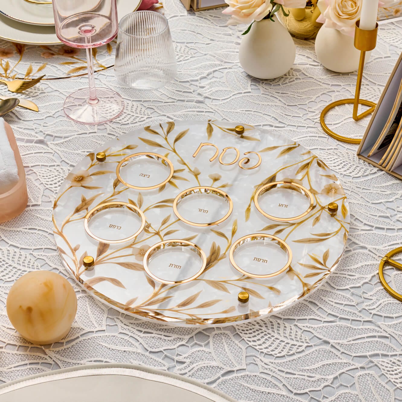 Modern round lucite Seder plate featuring an artistic floral vine pattern, gold-rimmed edges.