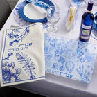 French Toile Challah Board and Cover Set with blue floral pattern on white linen, displayed with table setting and wine glasses.