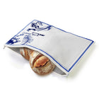 White French toile challah cover with blue delicate pattern and leather handles, displayed with fresh challah bread inside for Shabbat table.