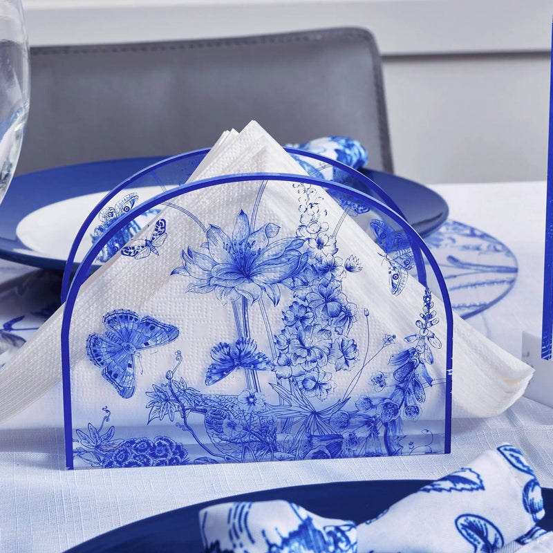 French Toile Napkin Holder in blue and white porcelain with classic scenic pattern, displayed on table setting with navy accents.