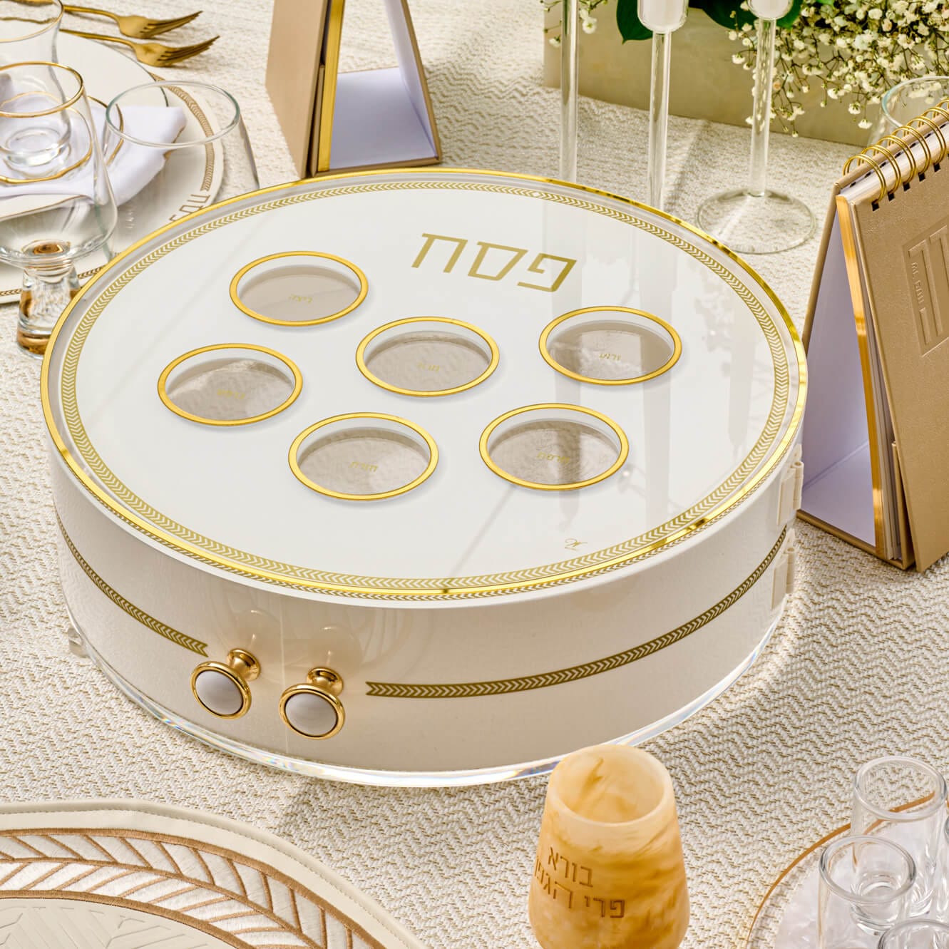 Herringbone 3-level Seder plate with a modern white and gold geometric pattern and gold-rimmed ritual food bowls.