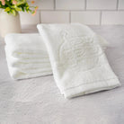 Two white al netillas yadayim towels on a textured surface