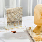 Jerusalem Taupe Tzedakah Box with gold Western Wall artwork, modern acrylic charity box with Hebrew Tzedakah lettering, elegant Judaica decor for Jewish home, synagogue, or Bar Mitzvah gift.