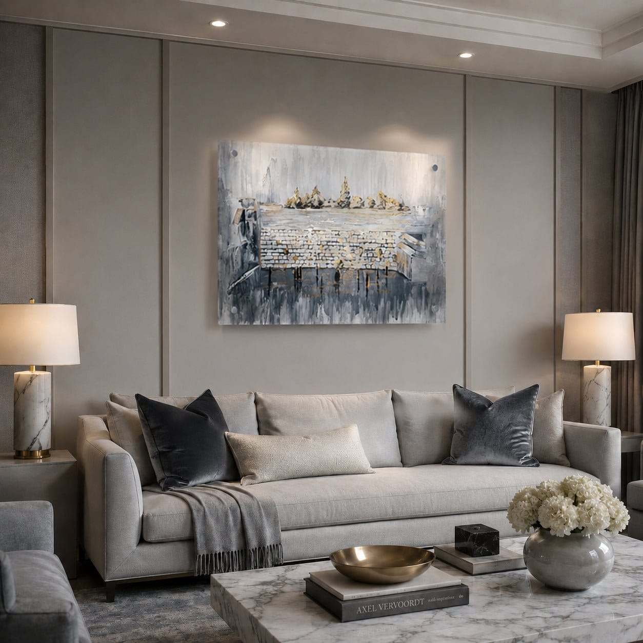 A modern living room featuring a large abstract canvas painting with blue, gray, and white tones of th ekosel , hung on a gray paneled wall above a light gray sofa.