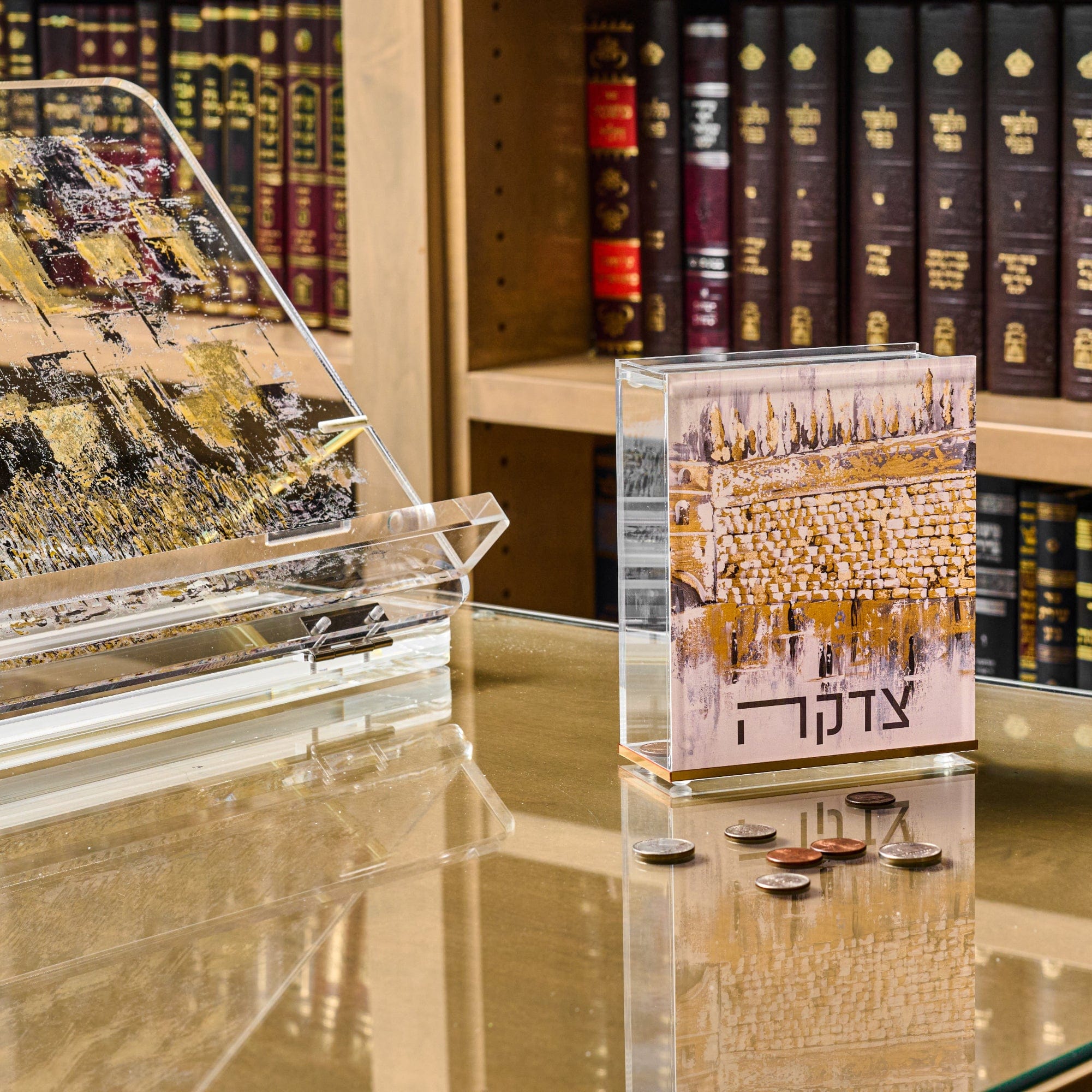 Kosel at Winter Tzedakah Box displayed on a glass table.