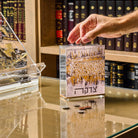 Kosel at Winter Tzedakah Box displayed on a glass table.
