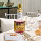Kosel at Winter Wine Decanter featuring rich red glass with gold Jerusalem skyline detailing and sleek gold stopper, luxury Judaica wine bottle for Shabbat and Yom Tov.