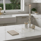 Leather hardcover Havdalah booklet with elegant beige leather cover set on a counter with havdalah set.