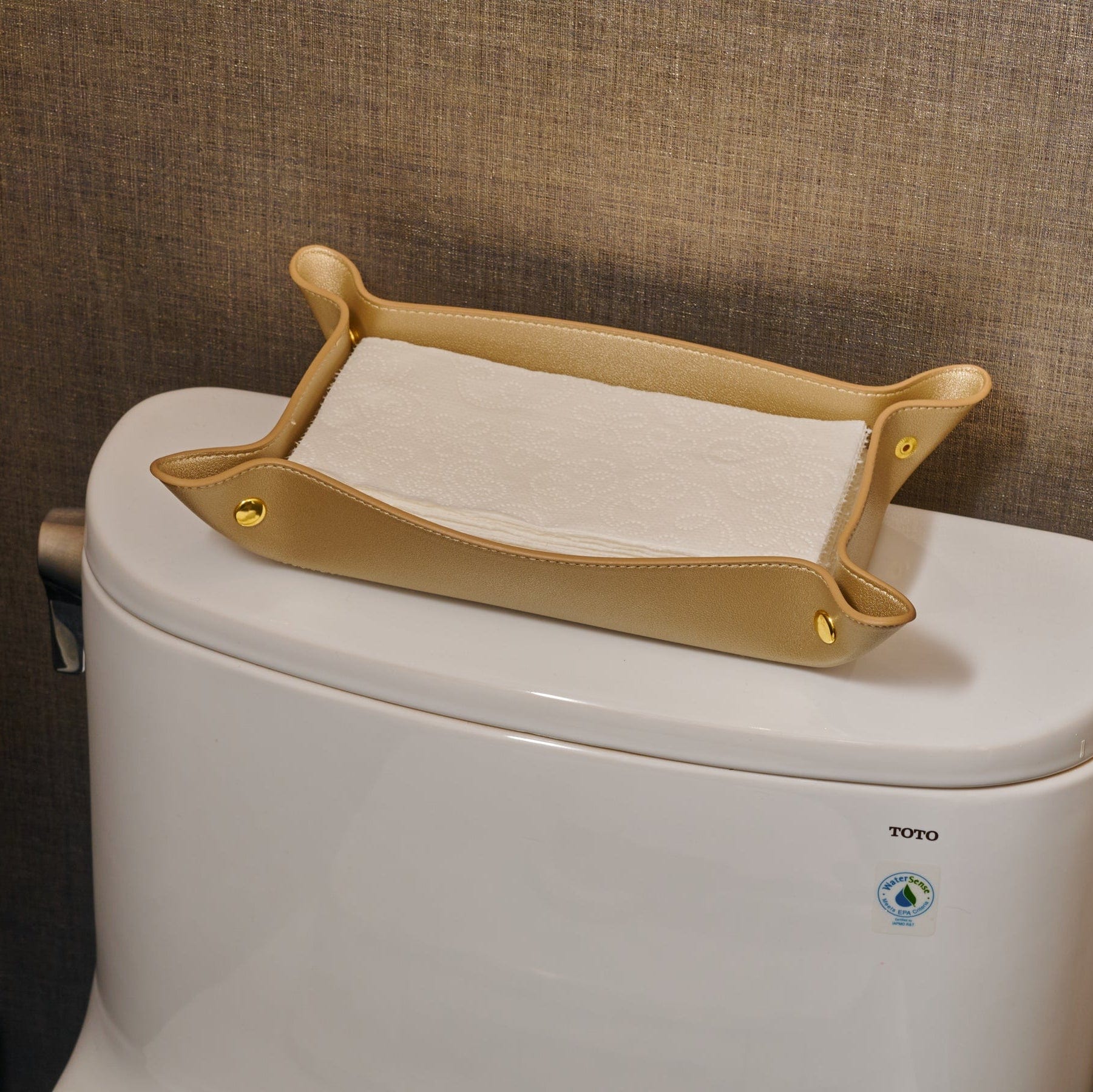 Gold Leather Shabbos Toilet Paper Holder displayed on a toilet tank in a modern bathroom