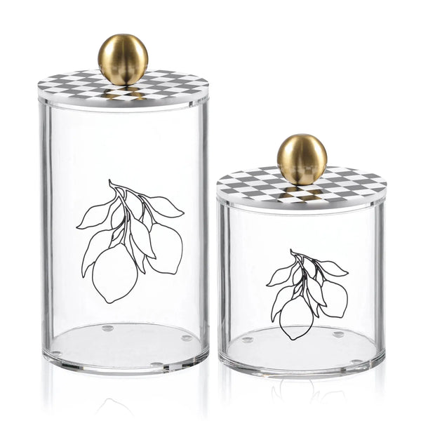 Two clear glass Lemona Cylinder Canisters with lemon branch etchings and brass finials in different sizes for kitchen storage.
