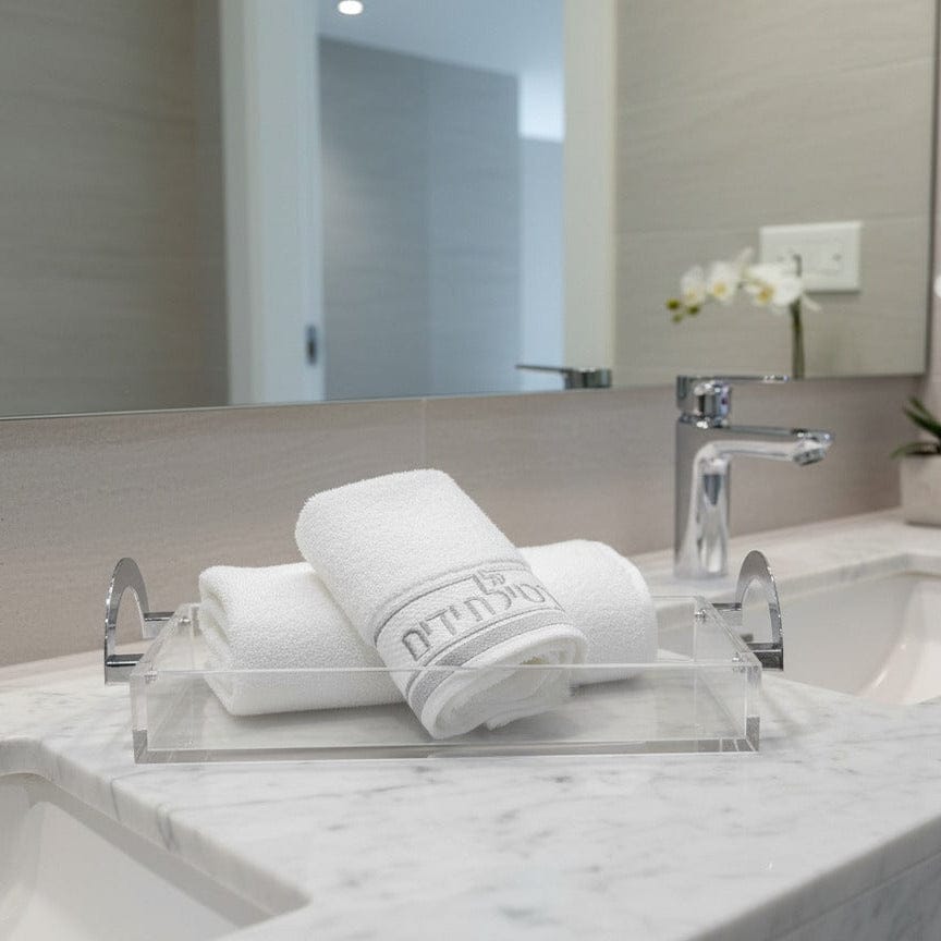 Bathroom with towels and a lucite tray from Waterdale Collection 