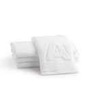 Stack of white Lux Towel Set by Waterdale Collection showing plush cotton towels folded neatly together