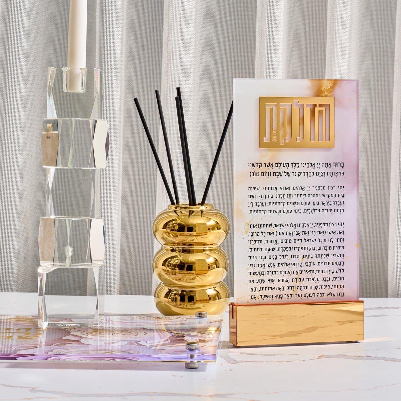 Decorative diffuser with gold accents and a card on a white surface