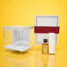 Marble silverware caddy with white marble base and clear acrylic sides, styled as part of an elegant Mishloach Manos gift display.