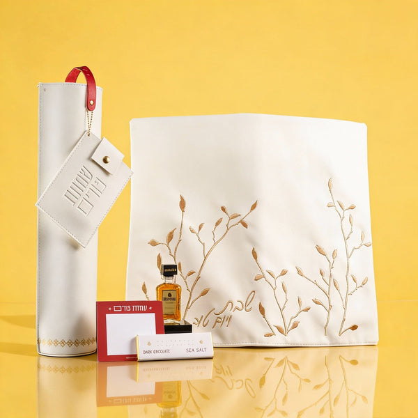 Elegant Mishloach Manot gift basket for Purim featuring premium wine, Hebrew-themed Judaica, and deluxe gift boxes